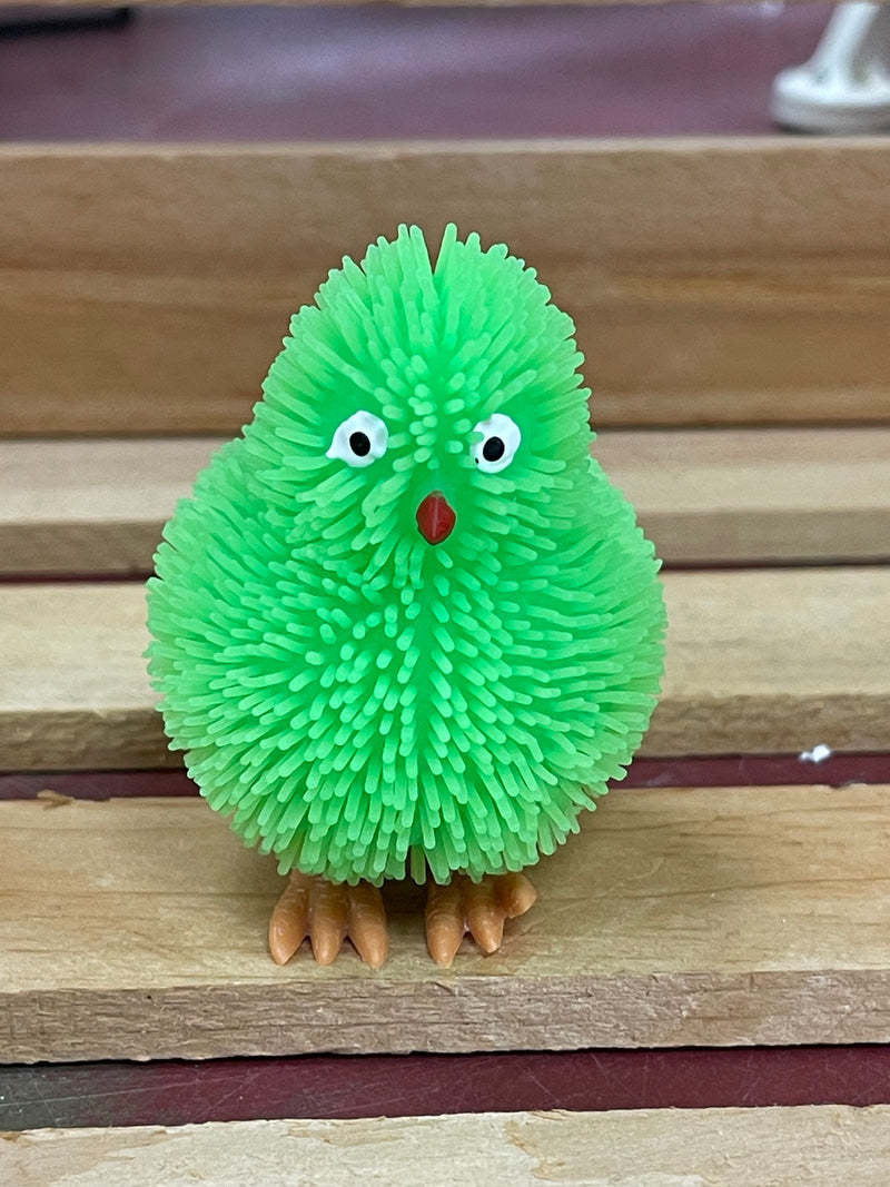 Green plastic toy chick with fringe that lights up when tossed.