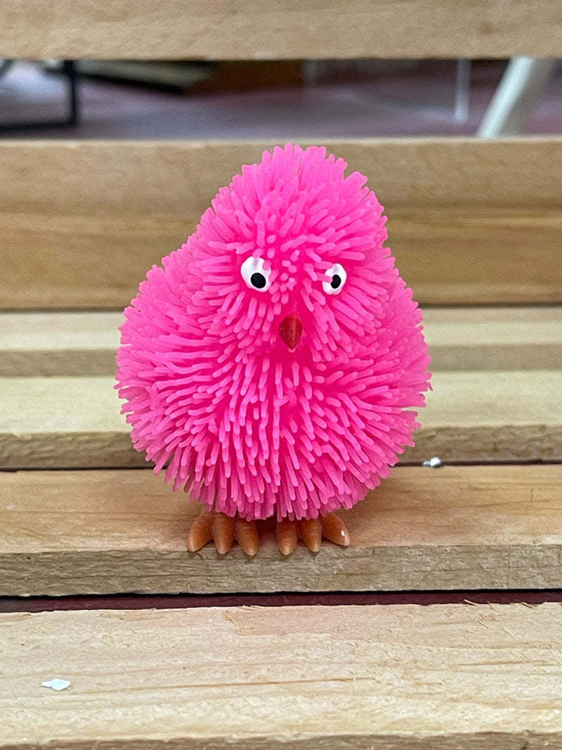 Pink plastic toy chick with glowing fringe lights up when tossed.