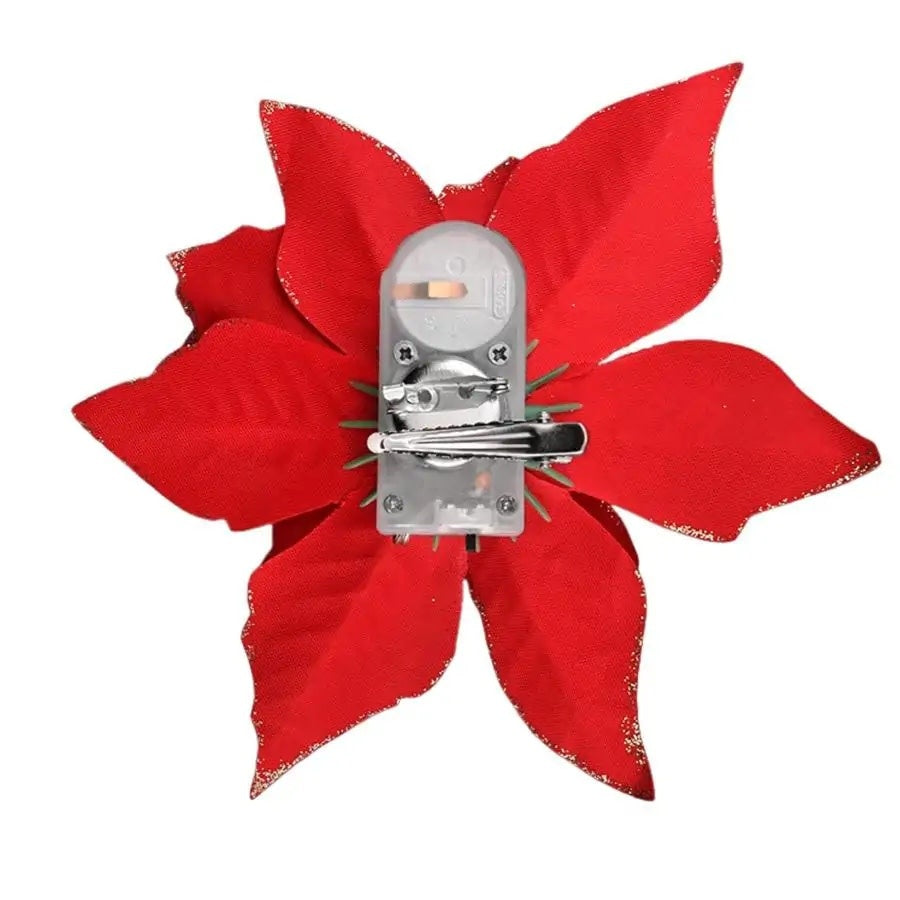 Red poinsettia hair clip with gold glitter outline and LED lights