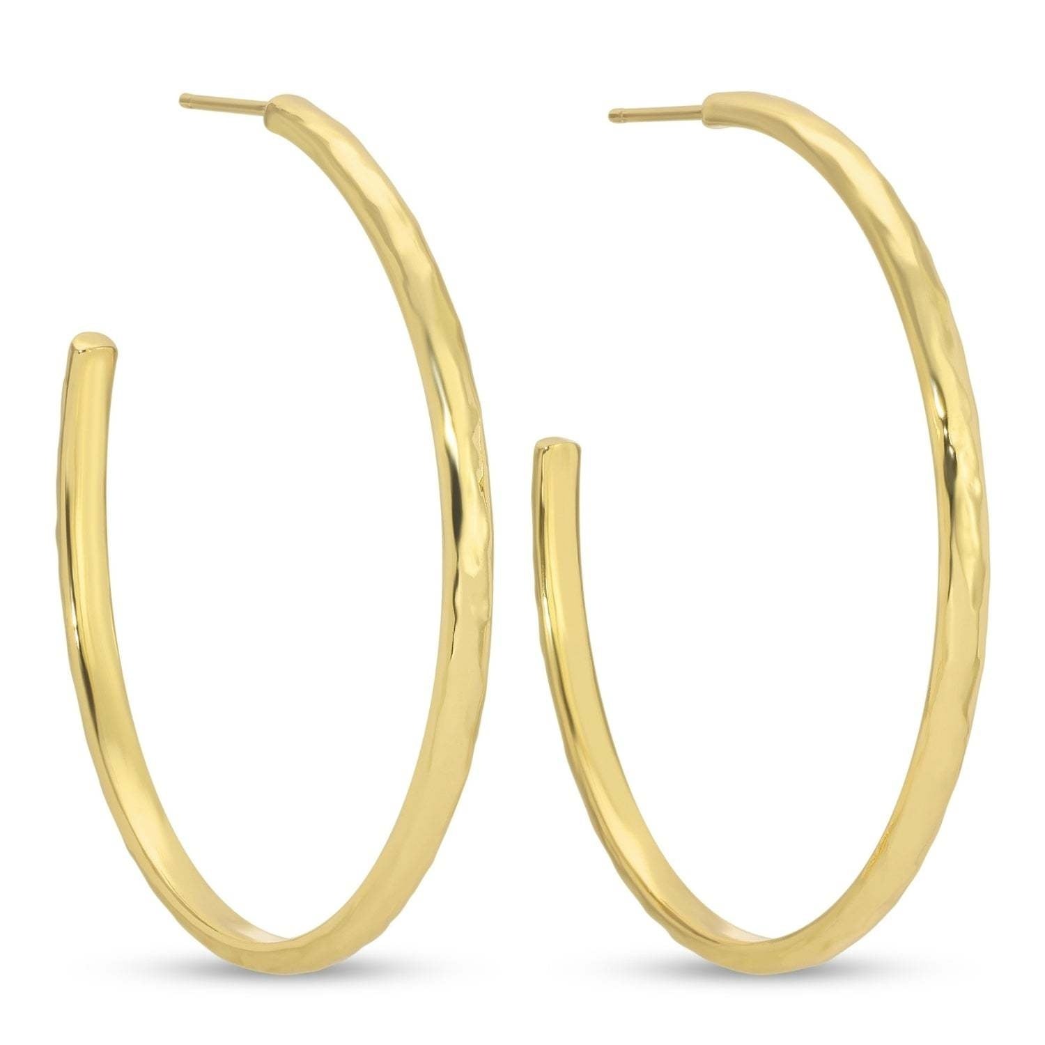 Large delicate hoop earrings with a lightly textured finish in gold.