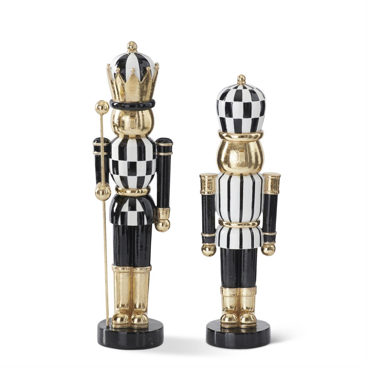 Two black, white, and gold resin nutcrackers with checkered and striped patterns.