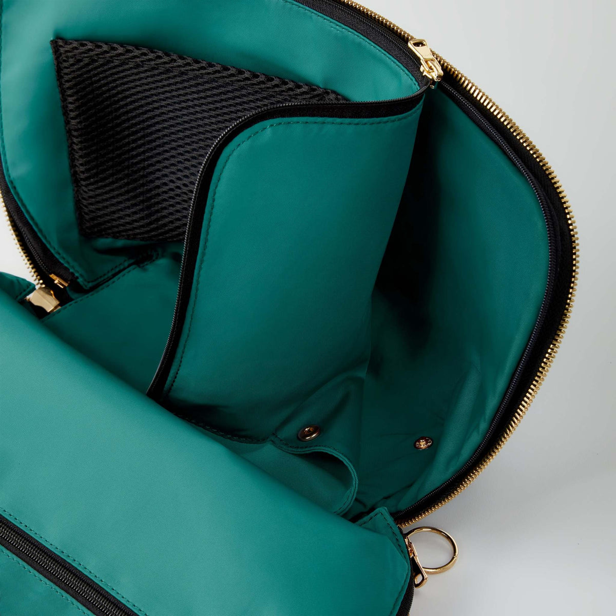 Emerald green Everyday Makeup Bag with gold hardware, three-sided zipper opening, interior mesh pockets, and removable lining.