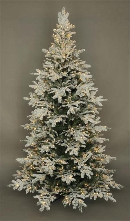 Lit flocked Noble Fir artificial Christmas tree with snow-like texture and LED lights