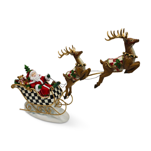 Illuminated Santa in a checkered sleigh pulled by two flying reindeer on a snowy base.
