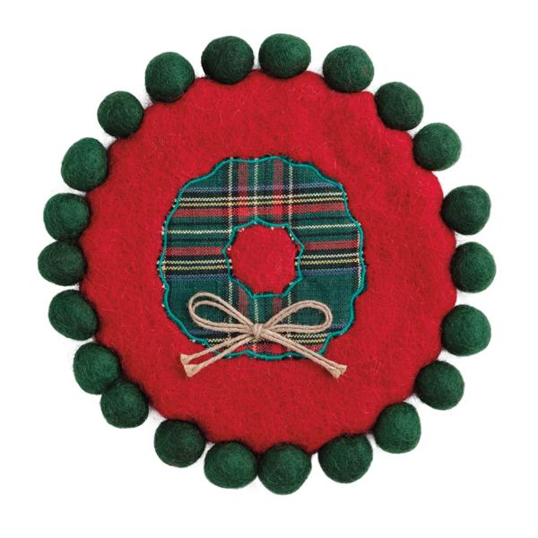 Round felted wool trivet with pom trim in classic Christmas red.