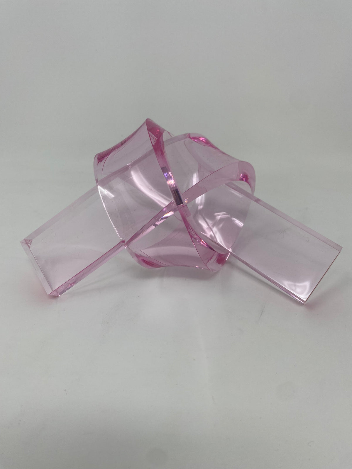 Acrylic knot pendant in clear acrylic with a silver-tone bail.