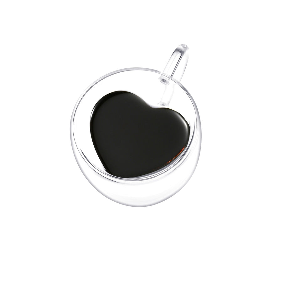 Top view of a double-walled clear glass espresso cup with a heart-shaped inner wall filled with coffee