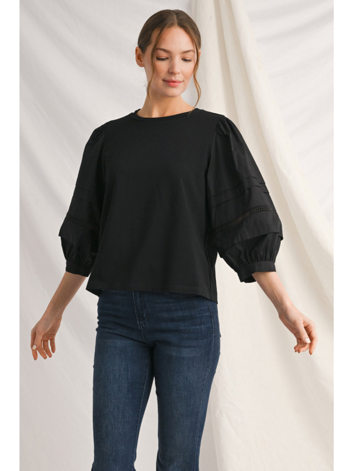 Alice solid top with ladder lace trim at neckline and button cuffs.