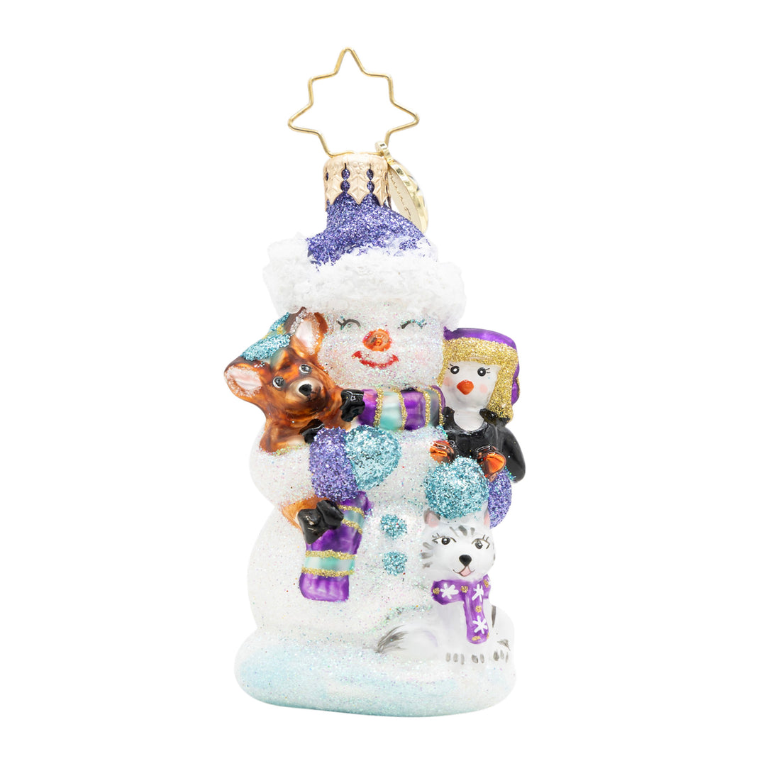 Snowman glass ornament wearing a purple hat, cuddling a deer, penguin, and husky dog.
