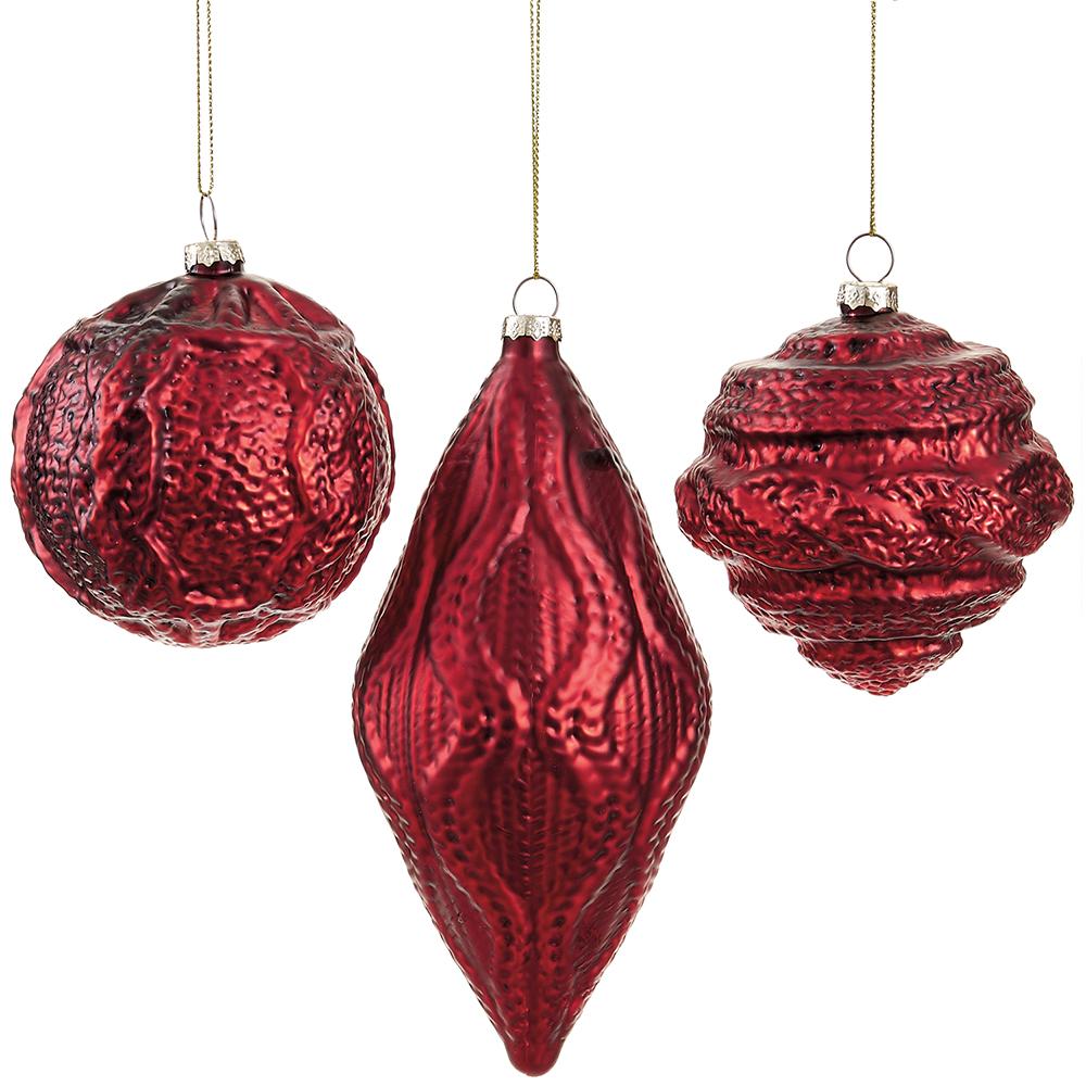 Three red textured glass Christmas ornaments in round, teardrop, and ribbed shapes.