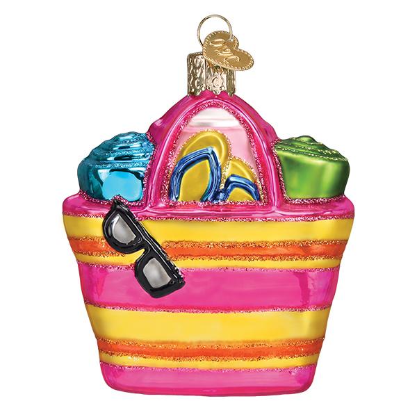 Glass beach bag ornament with pink and yellow stripes, sunglasses, flip flops, and rolled towels.
