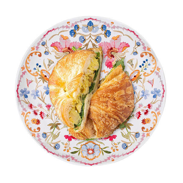 Sofia Melamine Dinner Plate in multi-color floral pattern with a croissant sandwich on top.