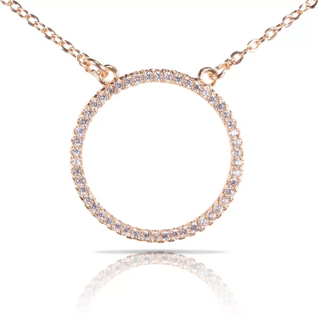 Ice Blu Circle Necklace in gold featuring a round pendant encrusted with small clear stones.