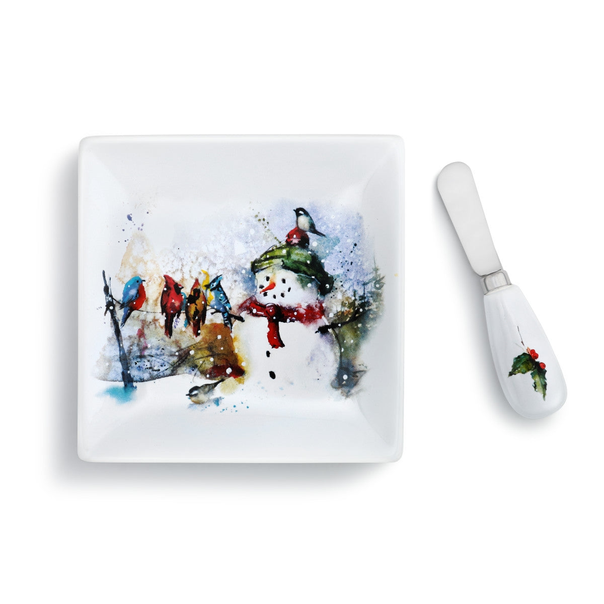 White square plate with a watercolor snowman and birds design, paired with a white spreader with a holly accent.