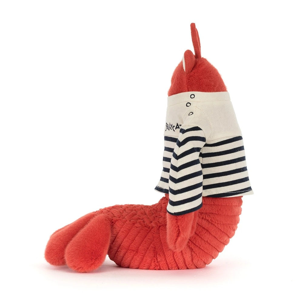 Side view of a red plush Jellycat lobster wearing a striped sailor shirt with a white collar.