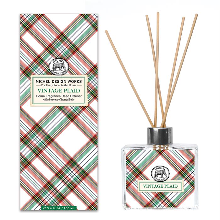 Home Fragrance Reed Diffuser with clear glass bottle containing light amber liquid and multiple reed sticks.