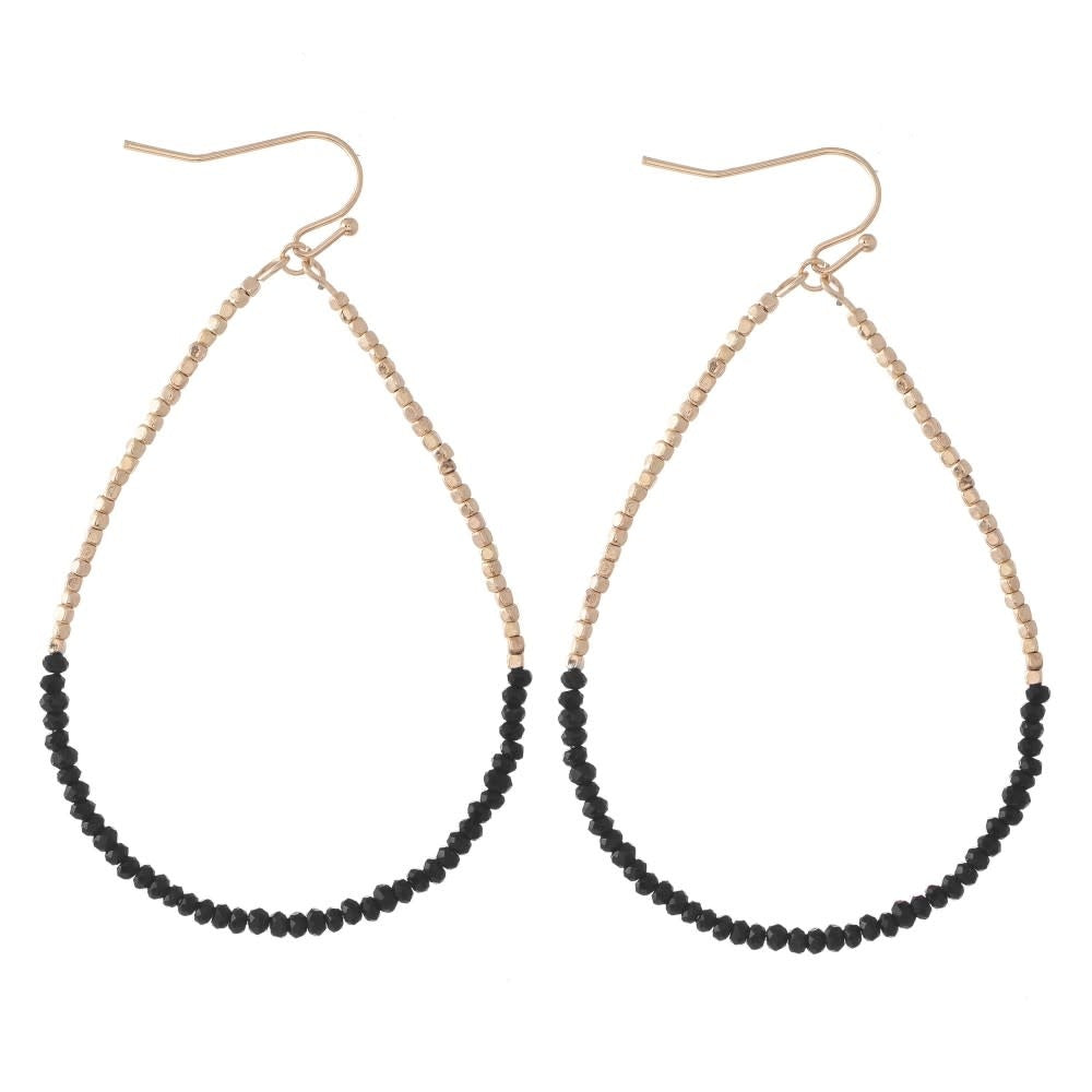 Black beaded teardrop earrings with a long dainty silhouette.