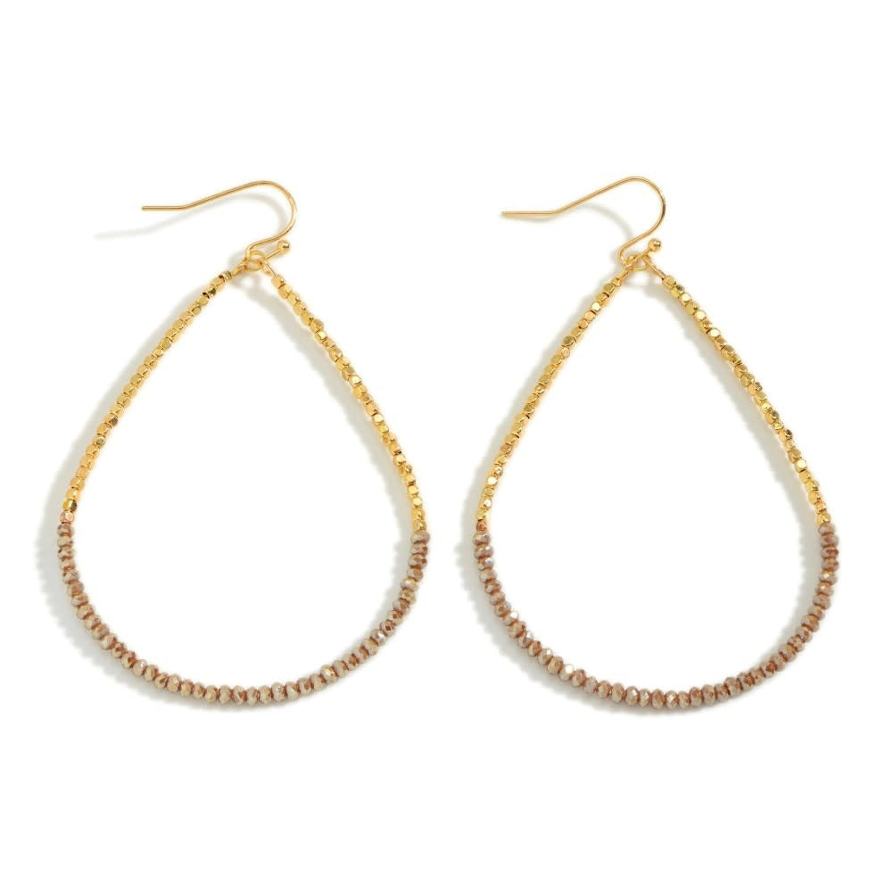 Long dainty beaded teardrop earrings in light brown with a vertical silhouette and small bead details.