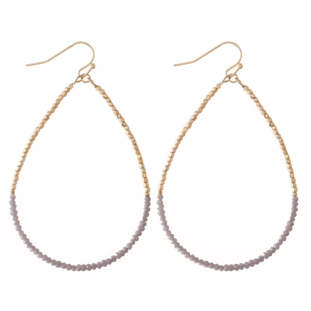 Long dainty beaded teardrop earrings with a vertical drop silhouette.