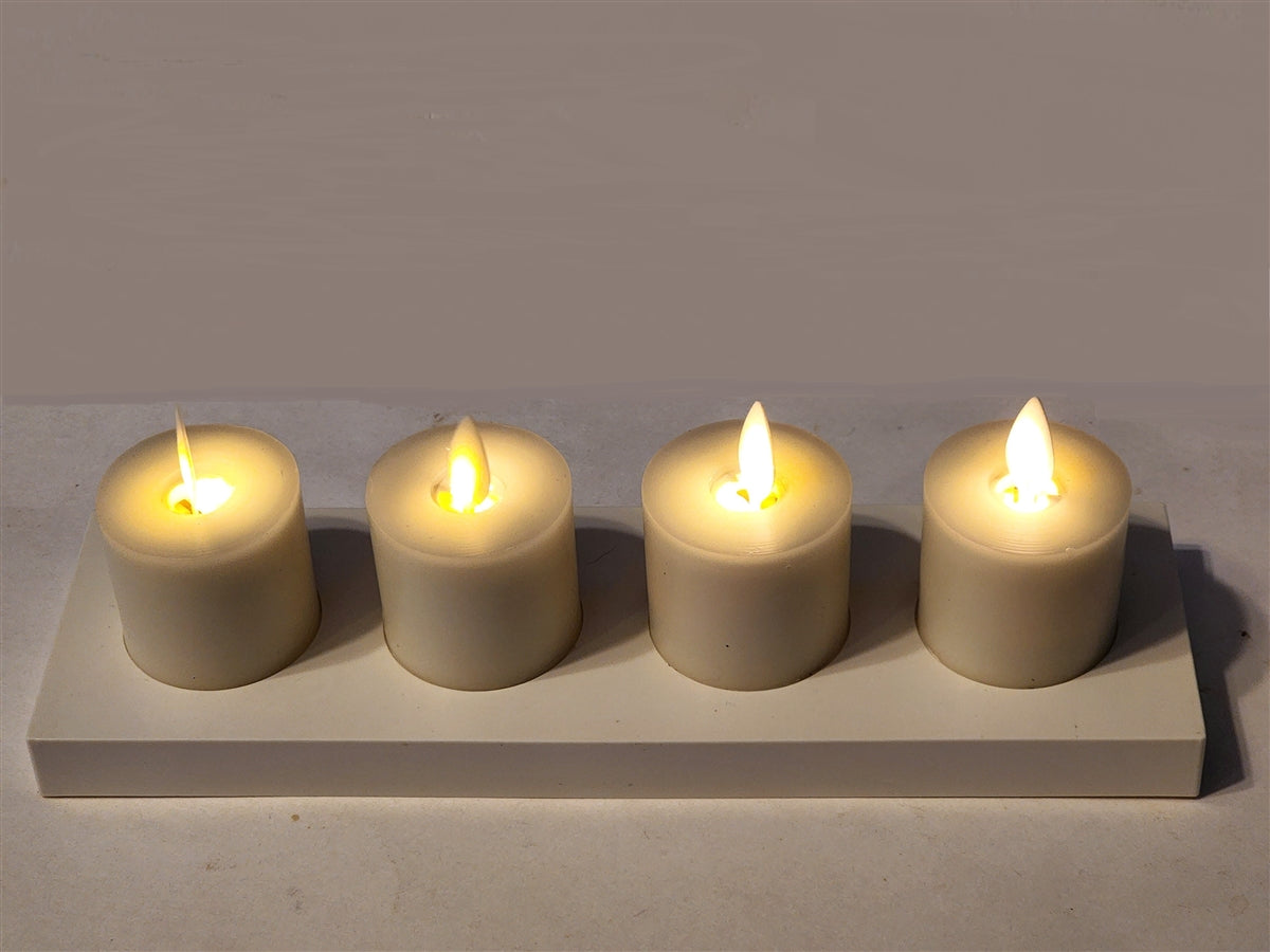 Four cream paraffin wax rechargeable LED tealights with moving flames on a white charging base.