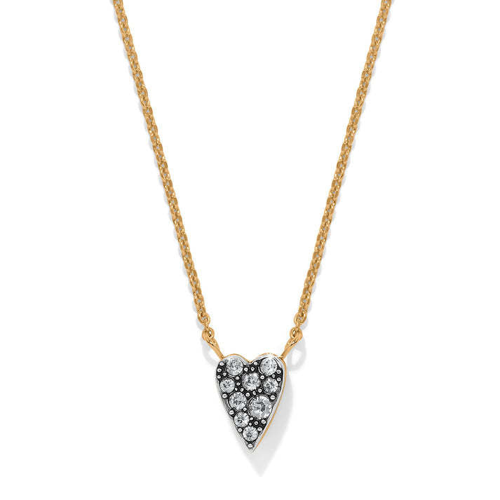 Reversible silver-gold necklace with sparkling heart pendant on one side.