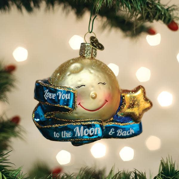 Mouth-blown glass ornament with silver accents featuring a heart-shaped moon silhouette surrounded by stars.