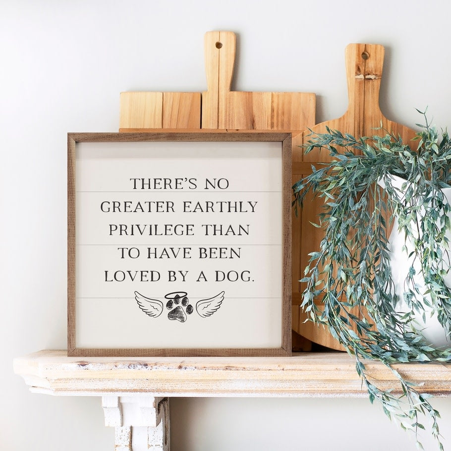 Hand-painted white Loved By A Dog wall art with natural walnut frame