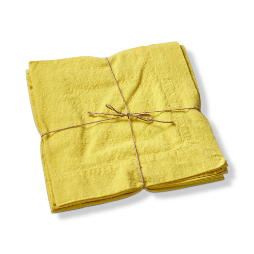 Set of yellow slub-textured fabric napkins tied together with a simple brown twine bow.