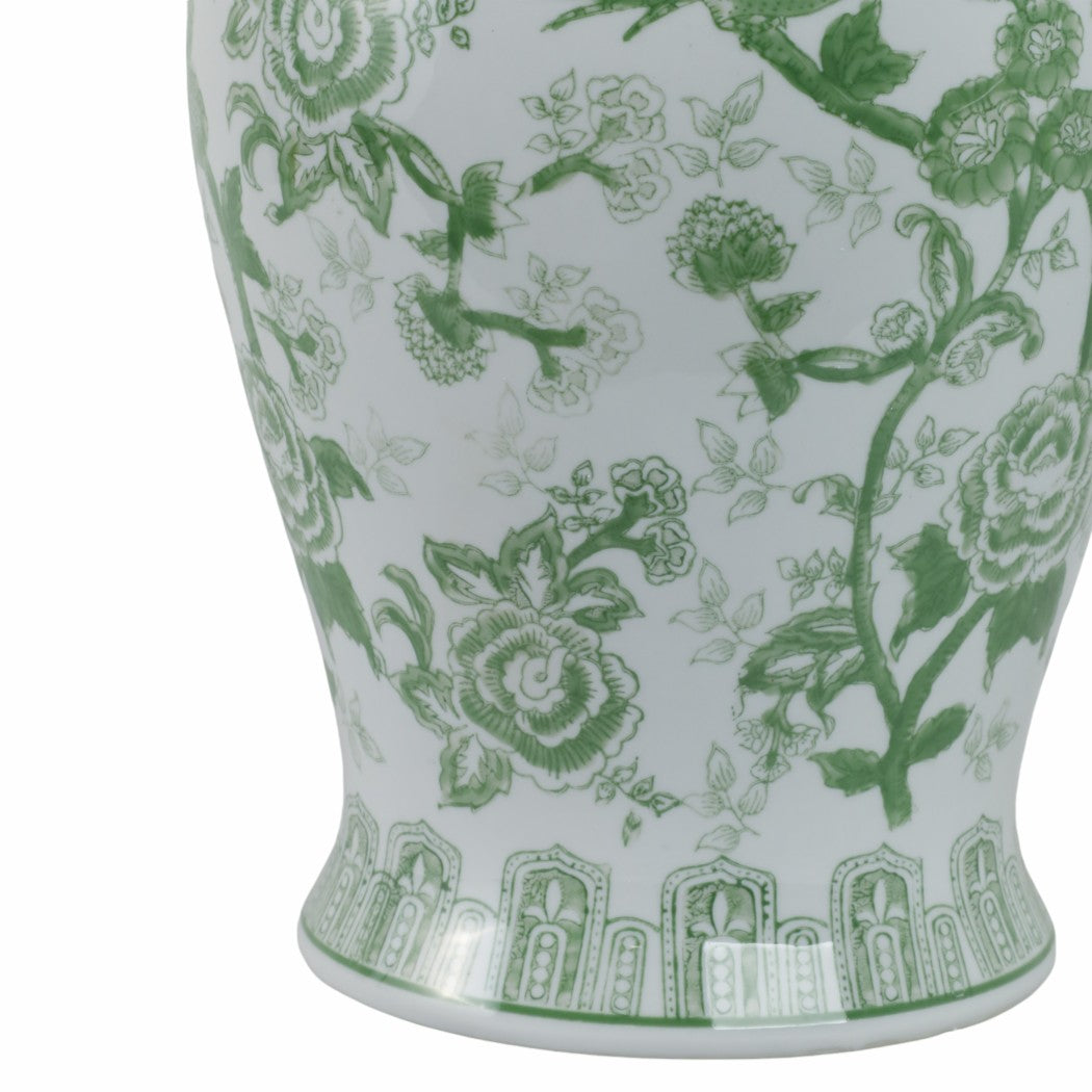 Close-up of a green and white ceramic temple jar featuring a floral and bird pattern.