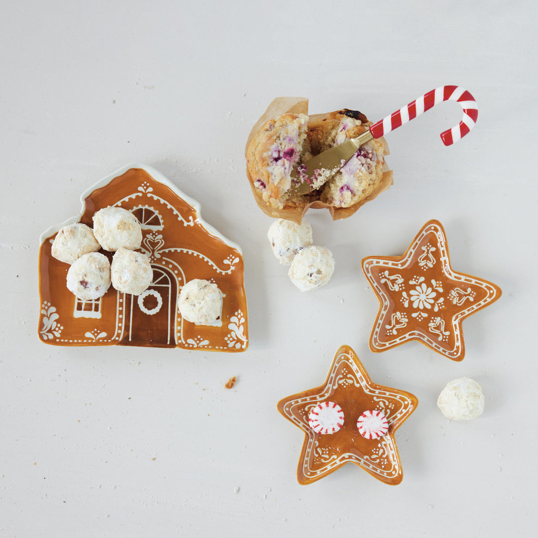 Stainless steel spreader with a red and white striped candy cane resin handle in a muffin.