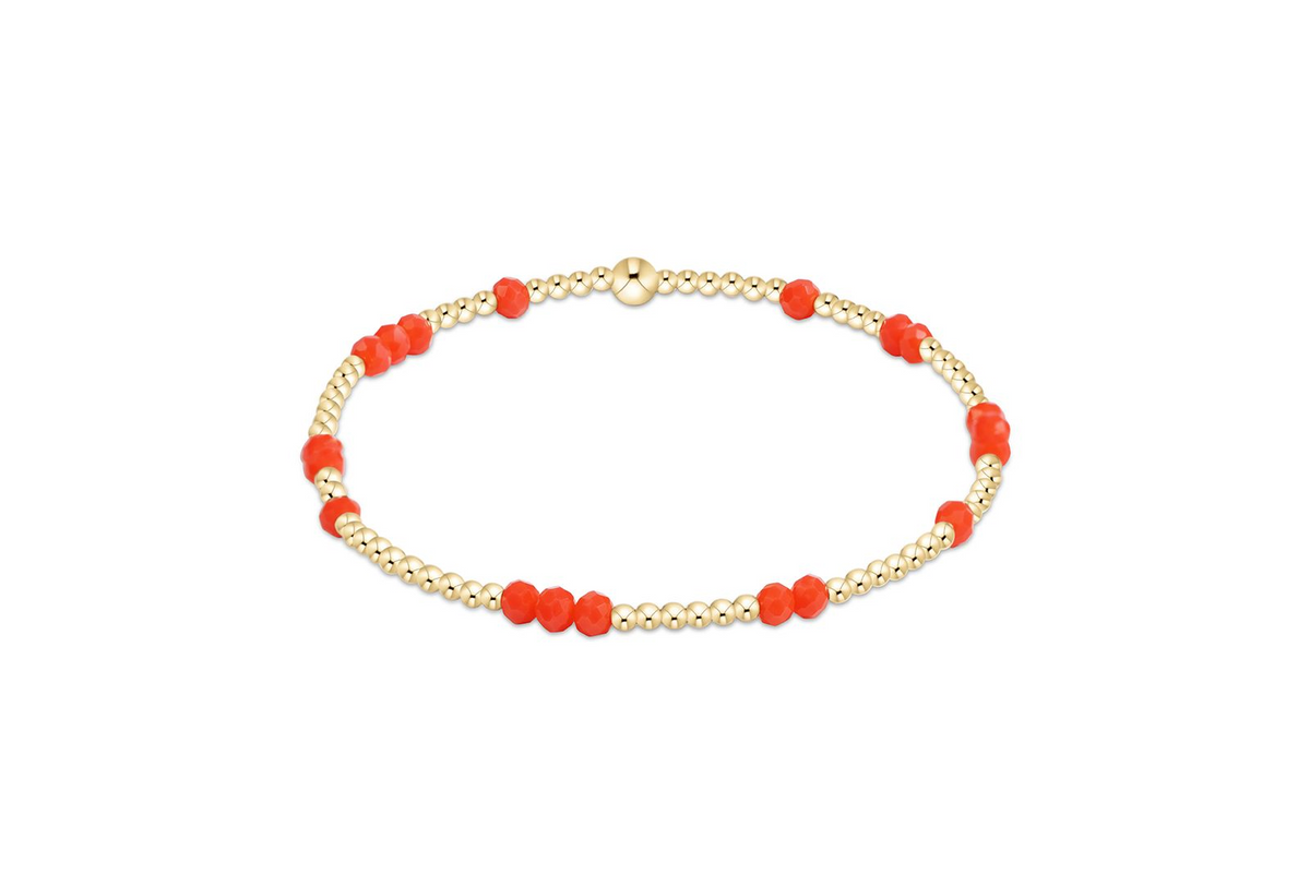 Gameday Flirty Hope Unwritten Bracelet with gold beads and faceted orange accents.