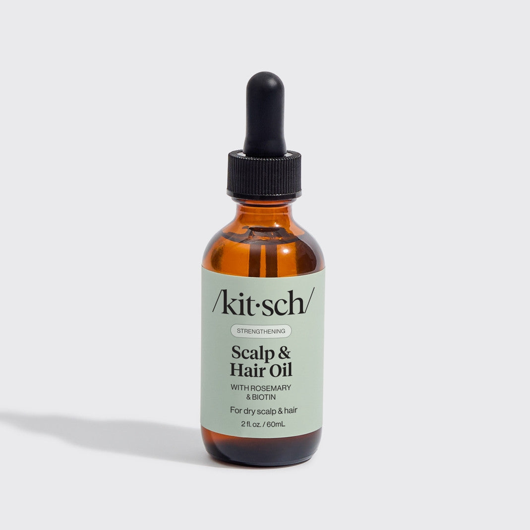 Kitsch Strengthening Scalp & Hair Oil with Rosemary and Biotin in a 2 fl. oz. amber glass bottle.
