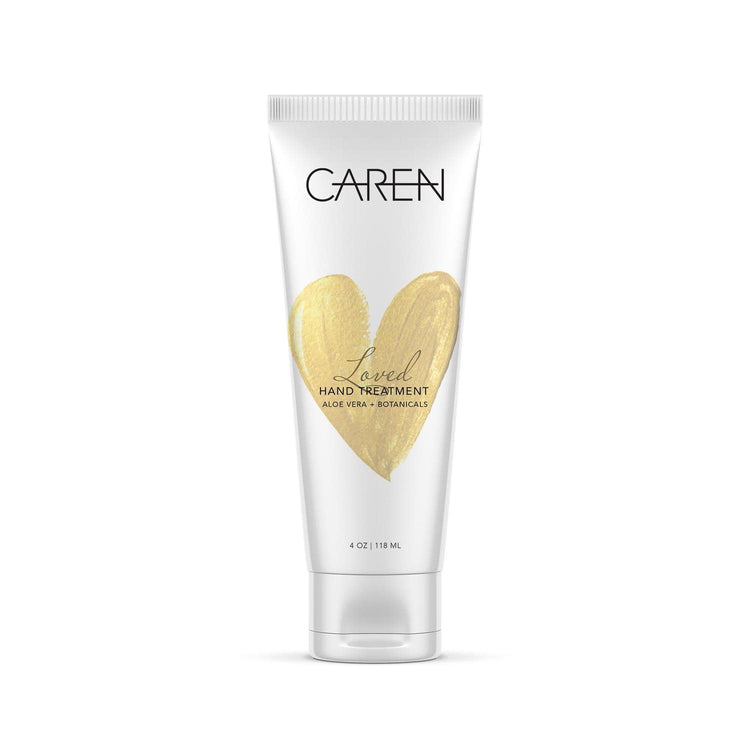 4 oz tube of Caren Loved Hand Treatment with a gold heart design and aloe vera + botanicals.