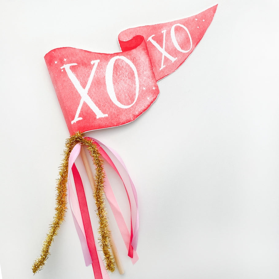Assembled wooden dowel party pennant featuring whimsical watercolor illustrations on textured paper.