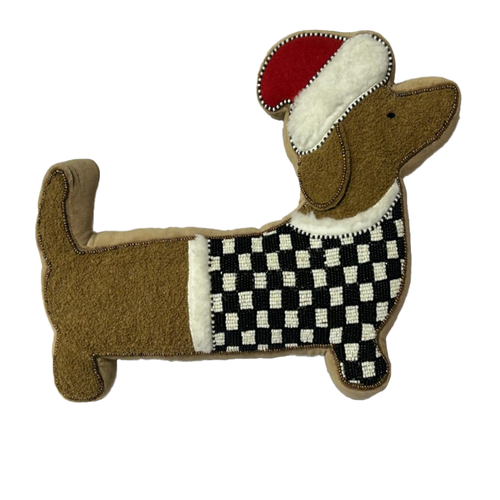 Dachshund shaped throw pillow wearing a Santa hat and a black and white checkered sweater.