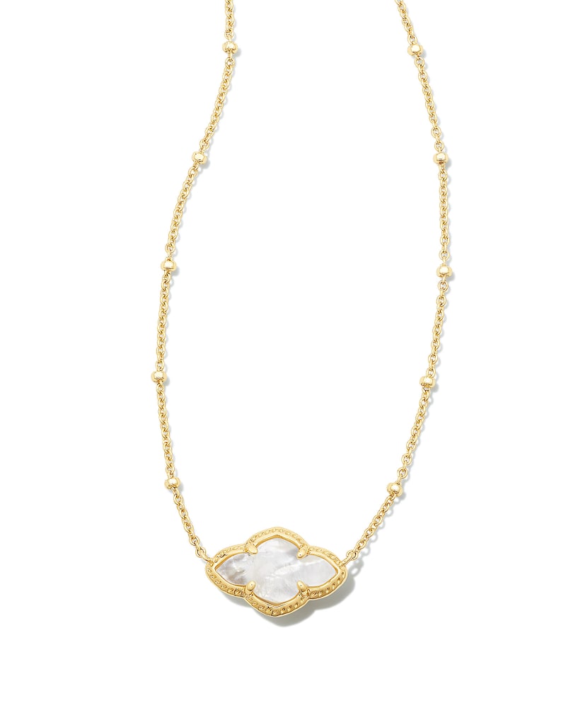 Abbie Pendant Necklace on an elongated chain with a medallion featuring joy and optimism motifs.