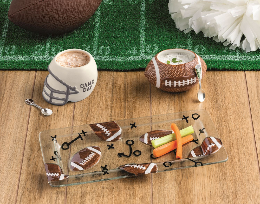 Rectangular glass tray with football and play diagram prints, holding carrot and celery sticks.