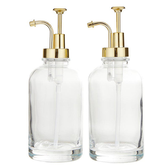 Two 16 oz clear glass coffee syrup dispensers with gold pumps.
