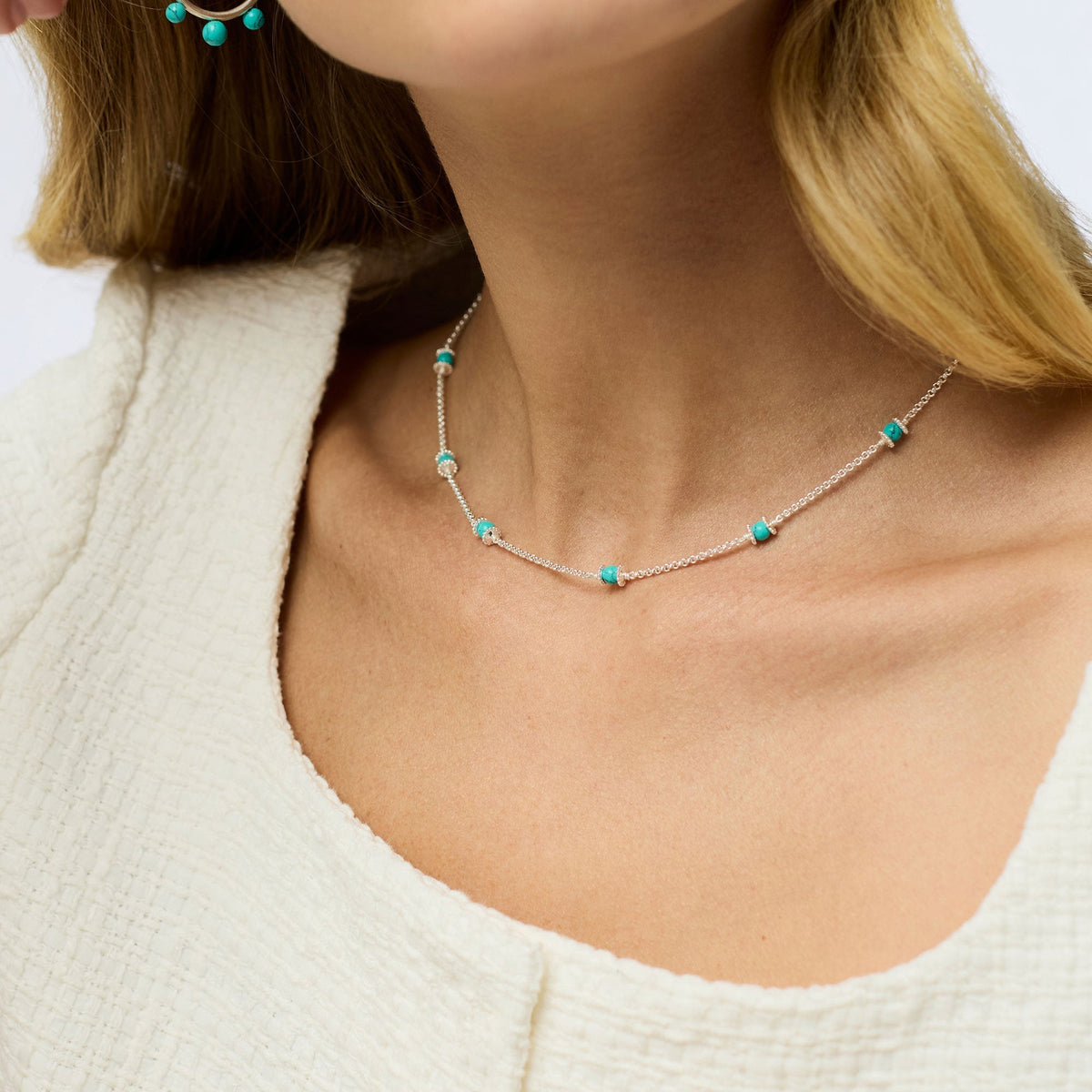 Silver plate necklace with adjustable chain length featuring a shell pearl pendant.