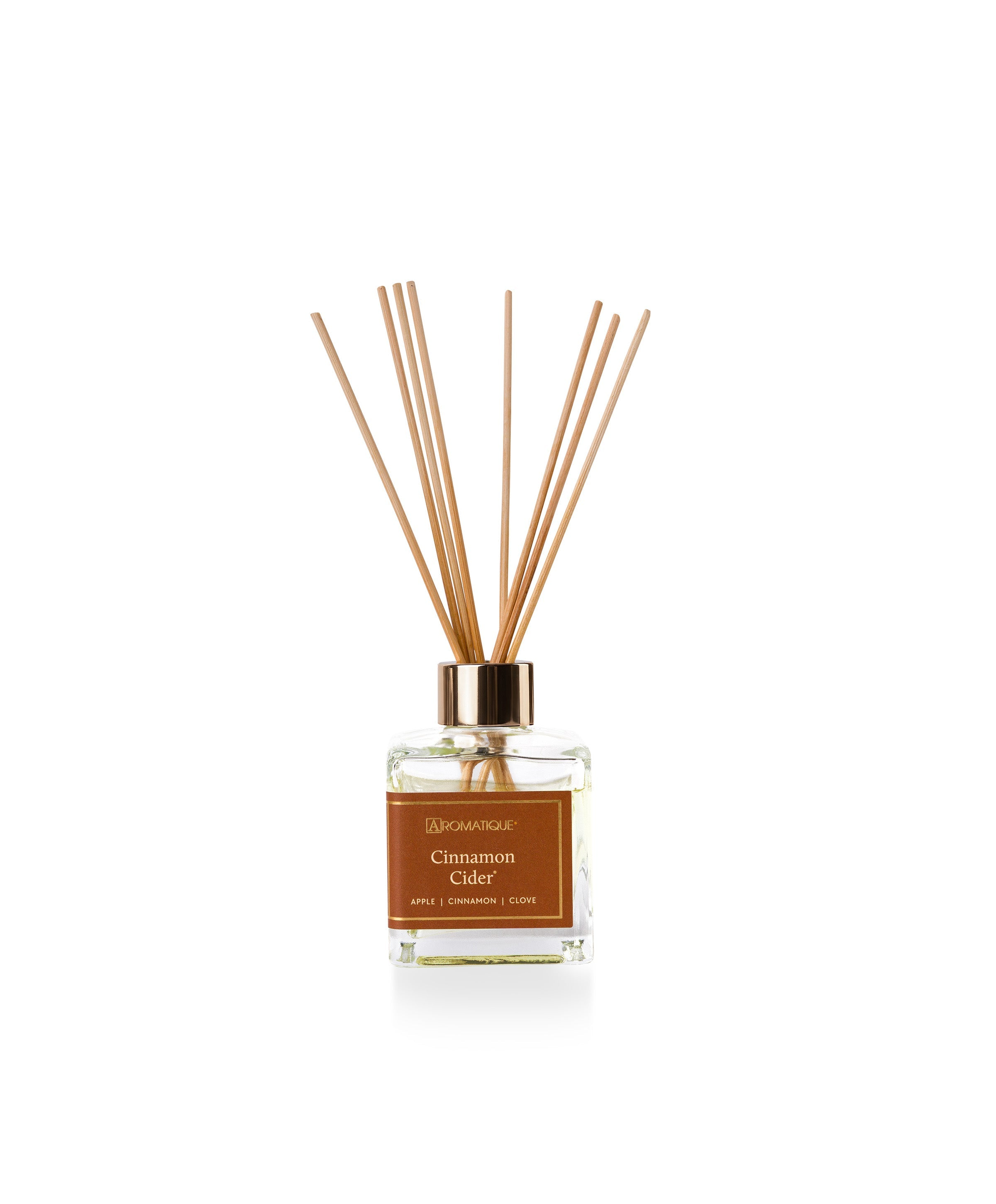 Cinnamon Cider reed diffuser set with a glass bottle, gold cap, and wooden reeds.