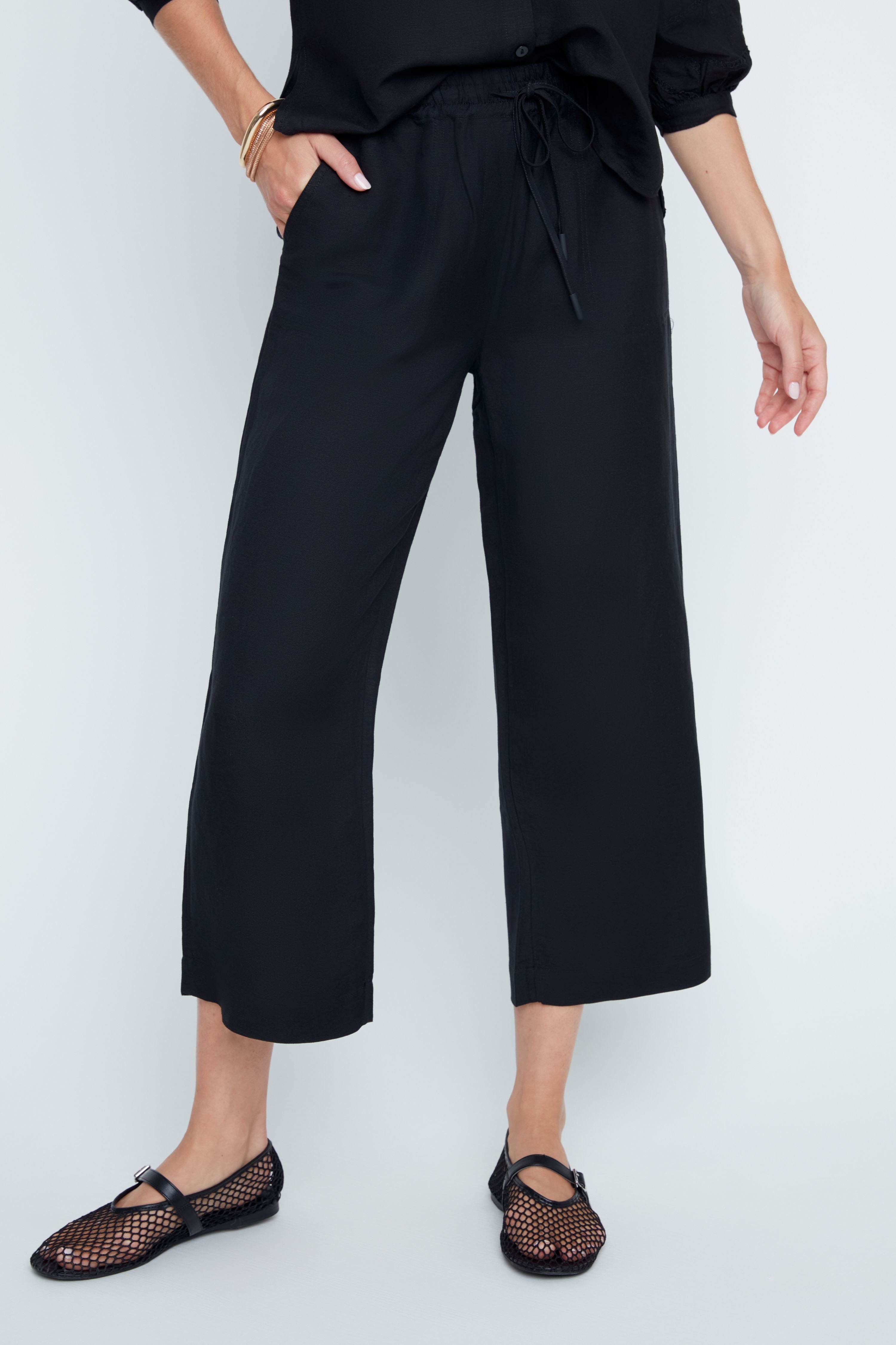 Victoria Woven Pant in beige with elastic waistband, drawstring, side pockets, and cropped relaxed silhouette.