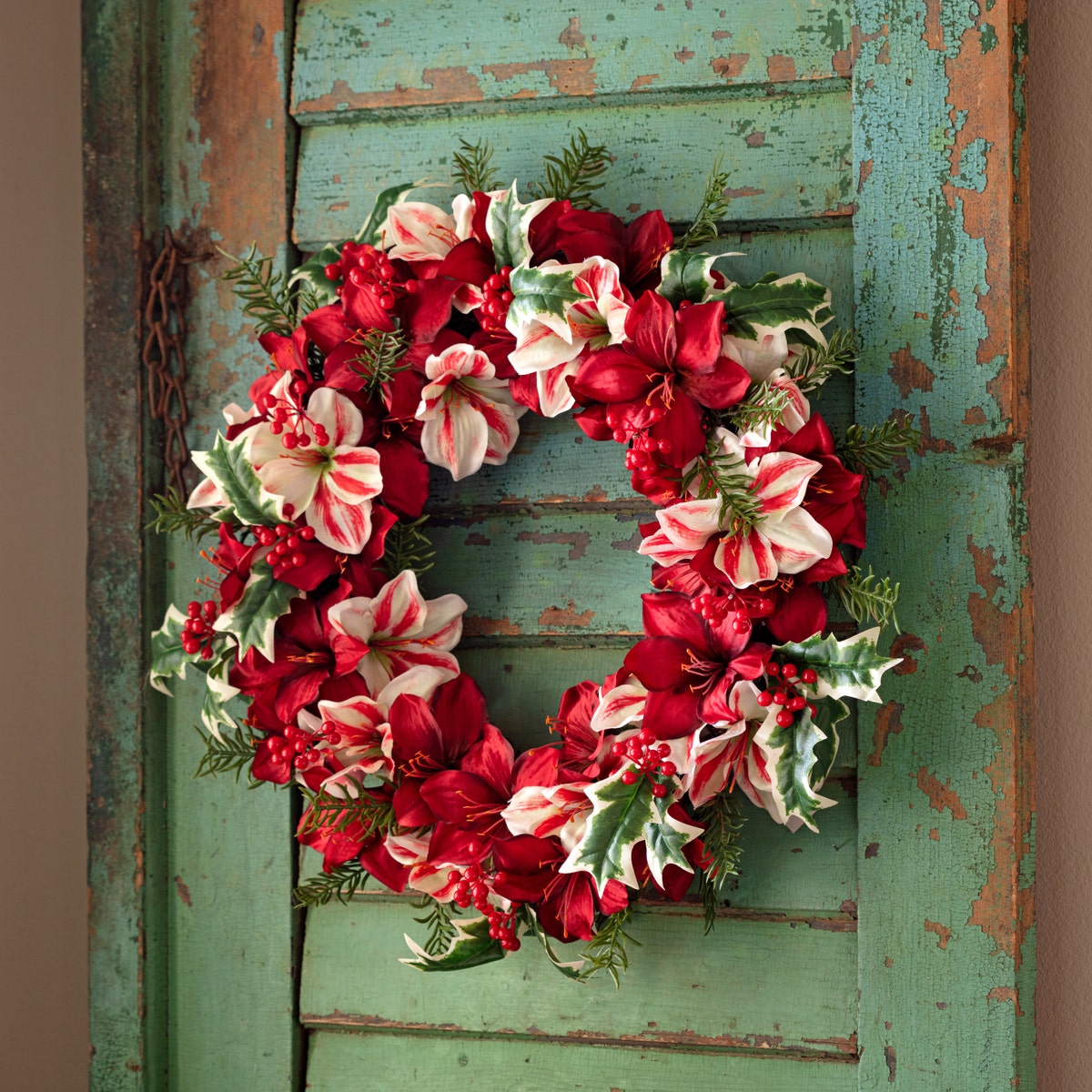 23-inch wreath featuring red and white candy cane amaryllis flowers on a rustic green door.