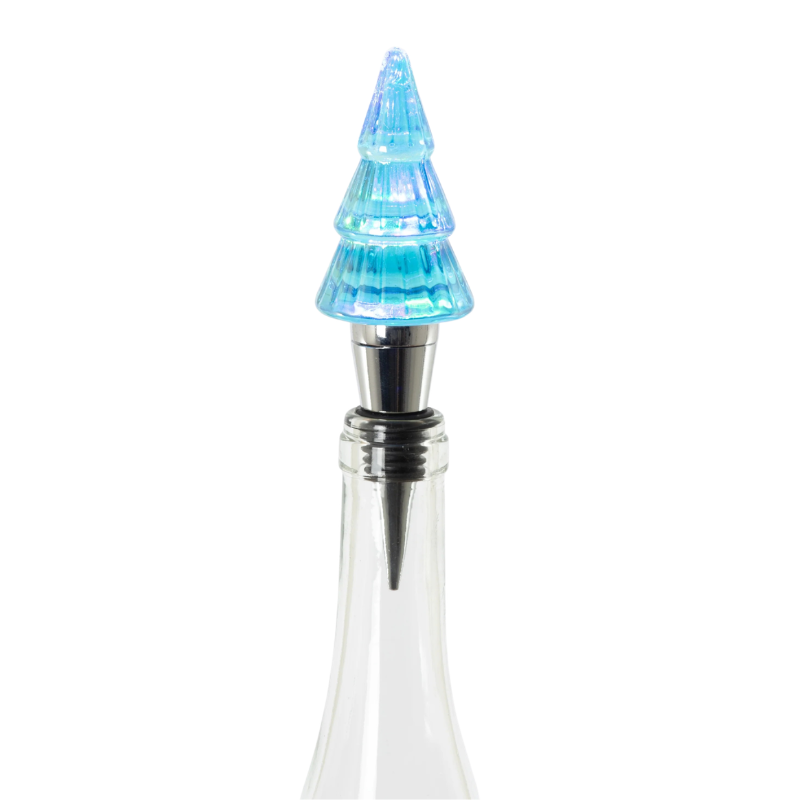 Lit blue glass Christmas tree bottle stopper with a silver metal base in a clear glass bottle.