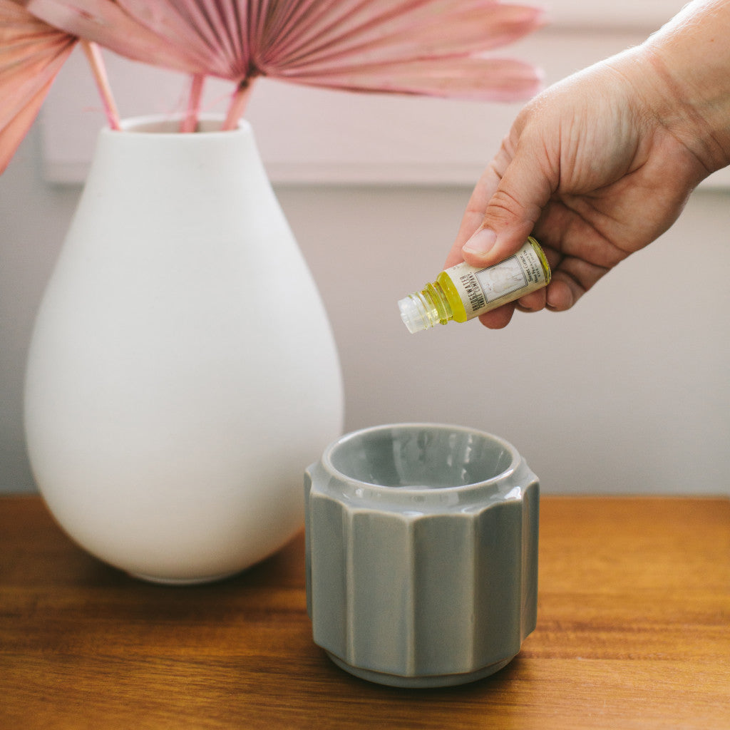 Glass bottle of Sweet Grace home fragrance oil with a pump dispenser.