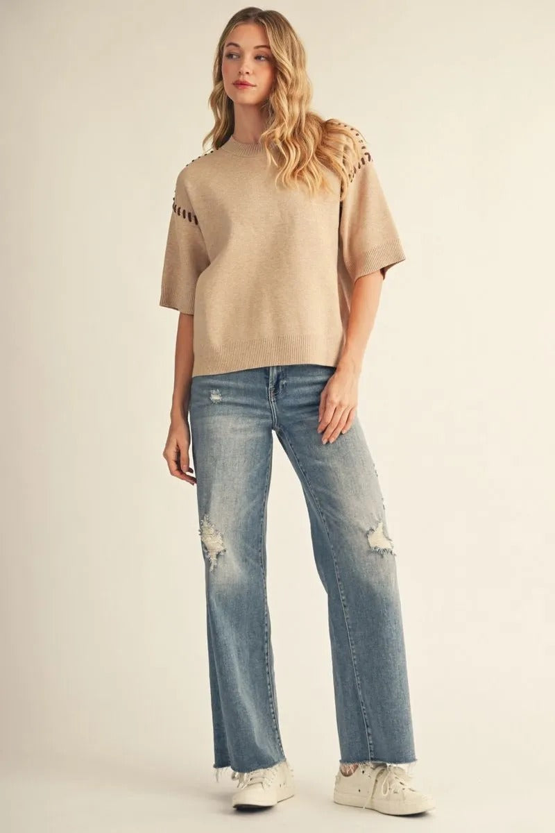 Woman wearing the Maxine Sweater Top in tan with short sleeves and whipstitch shoulder details.