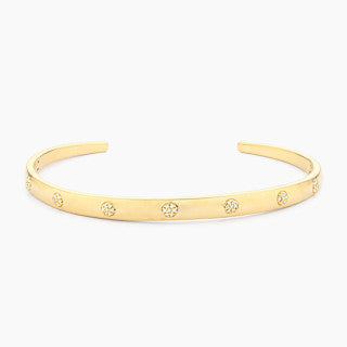 Open cuff bracelet in gold-plated stainless steel with a subtle lucky seven detail.