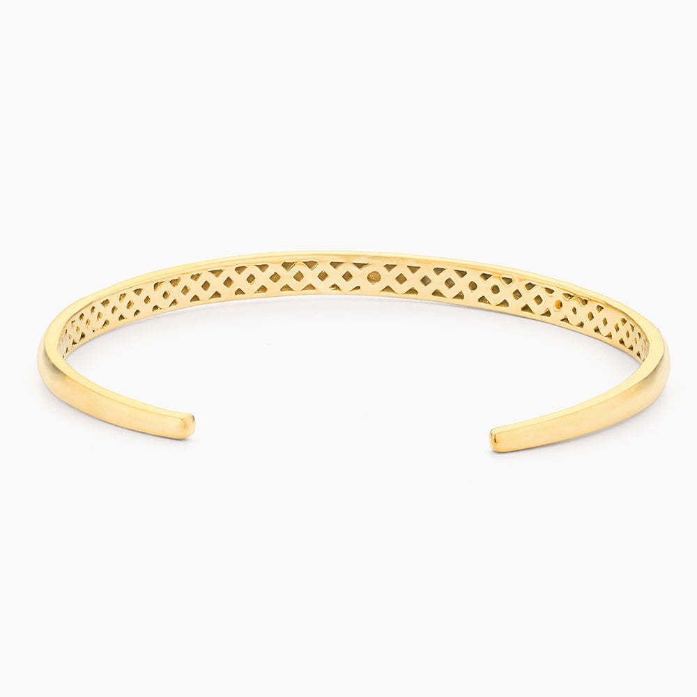Open cuff bracelet in gold-plated stainless steel with a subtle lucky number seven detail.