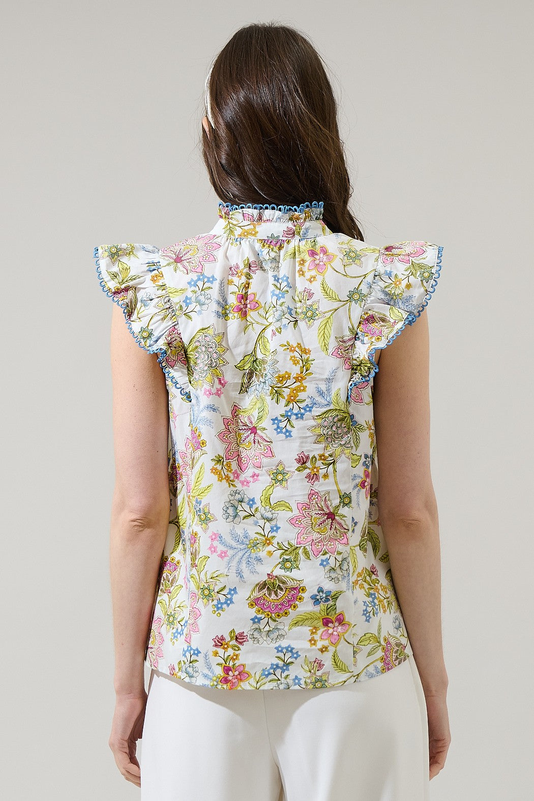 Elsa Pany Floral Rayen ruffle top in white cotton with a floral pattern and gathered neckline.