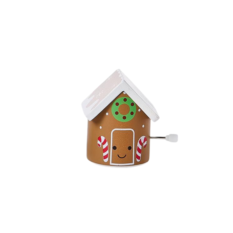 Wooden wind-up gingerbread house toy with a smiling face, candy canes, and a white roof.