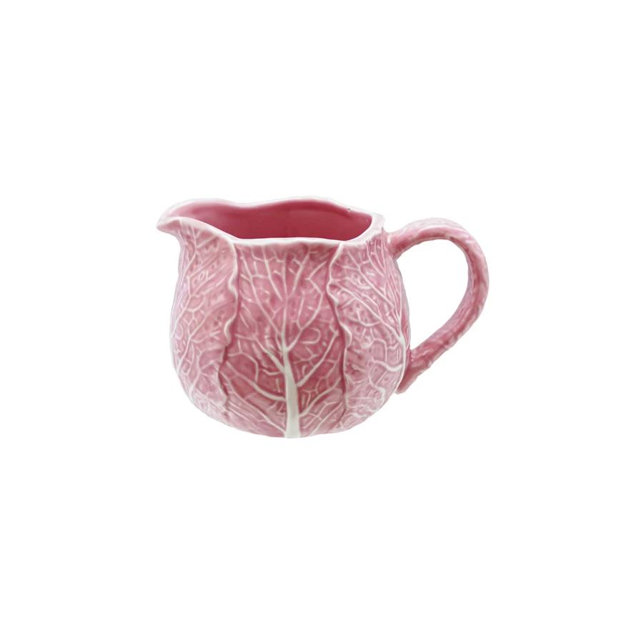 Pink stoneware creamer shaped like a cabbage with green leaf accents.